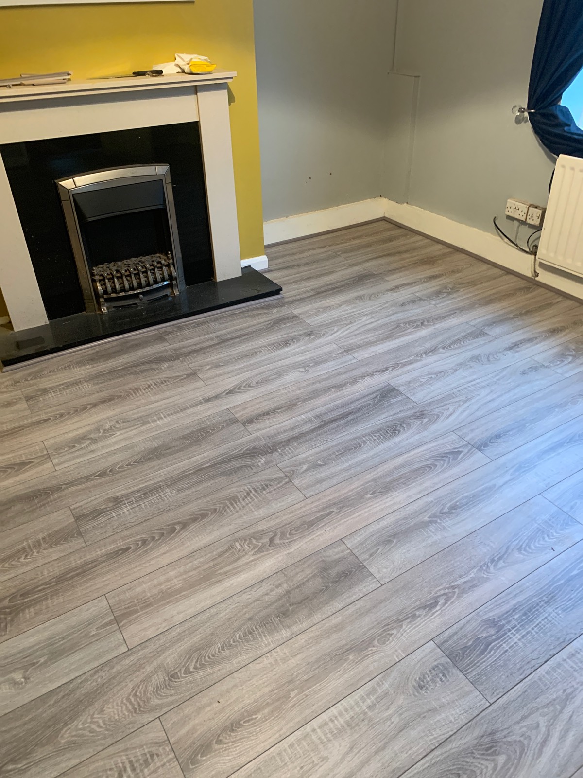 light laminate flooring in living room around fireplace