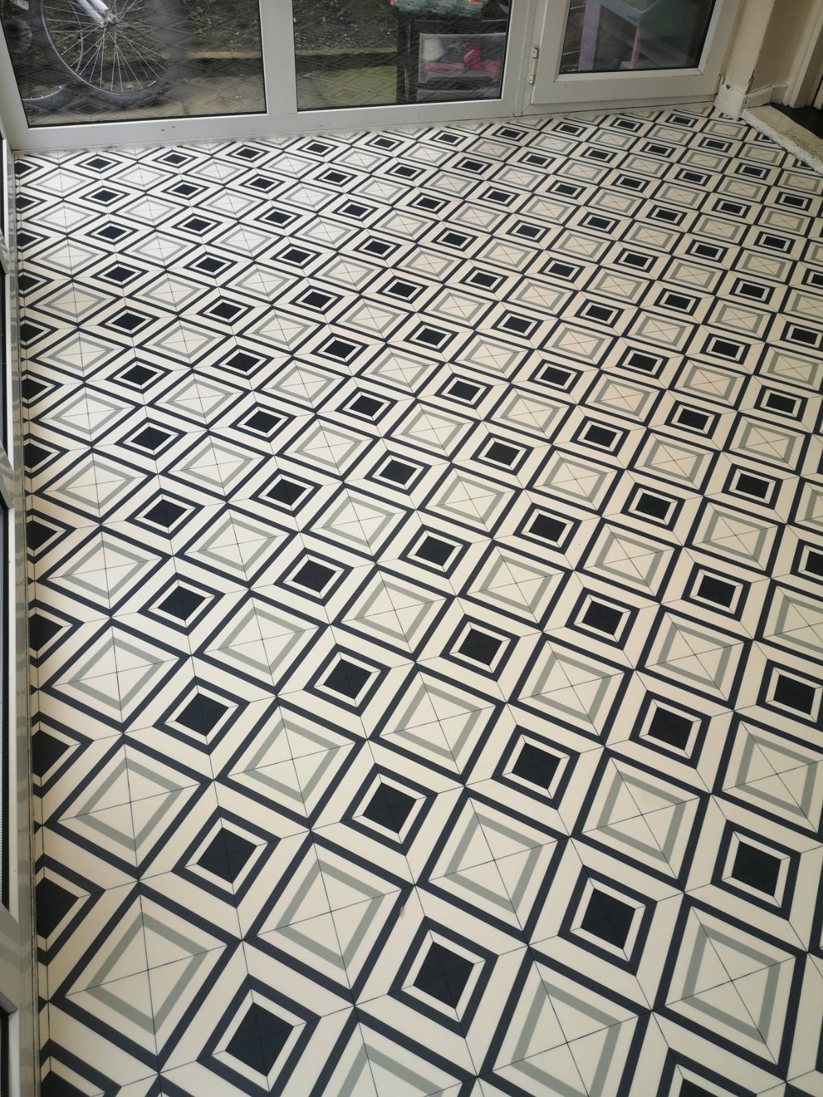 vinyl flooring with tile design in empty kitchen 