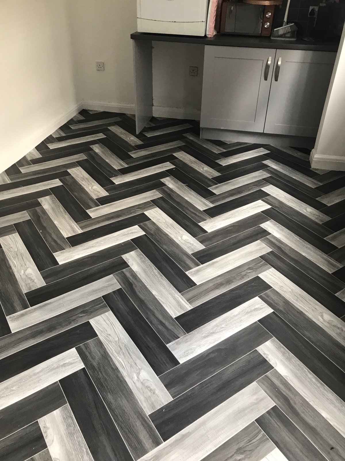 striped dark and white vinyl flooring in kitchen 
