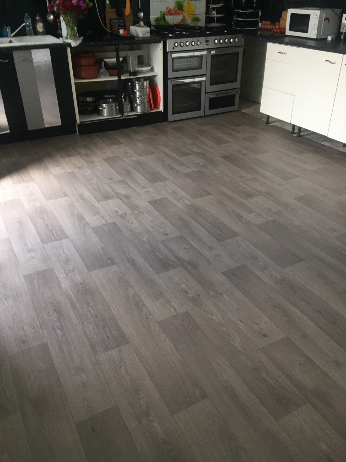 grey and brown vinyl flooring with wooden design in kitchen