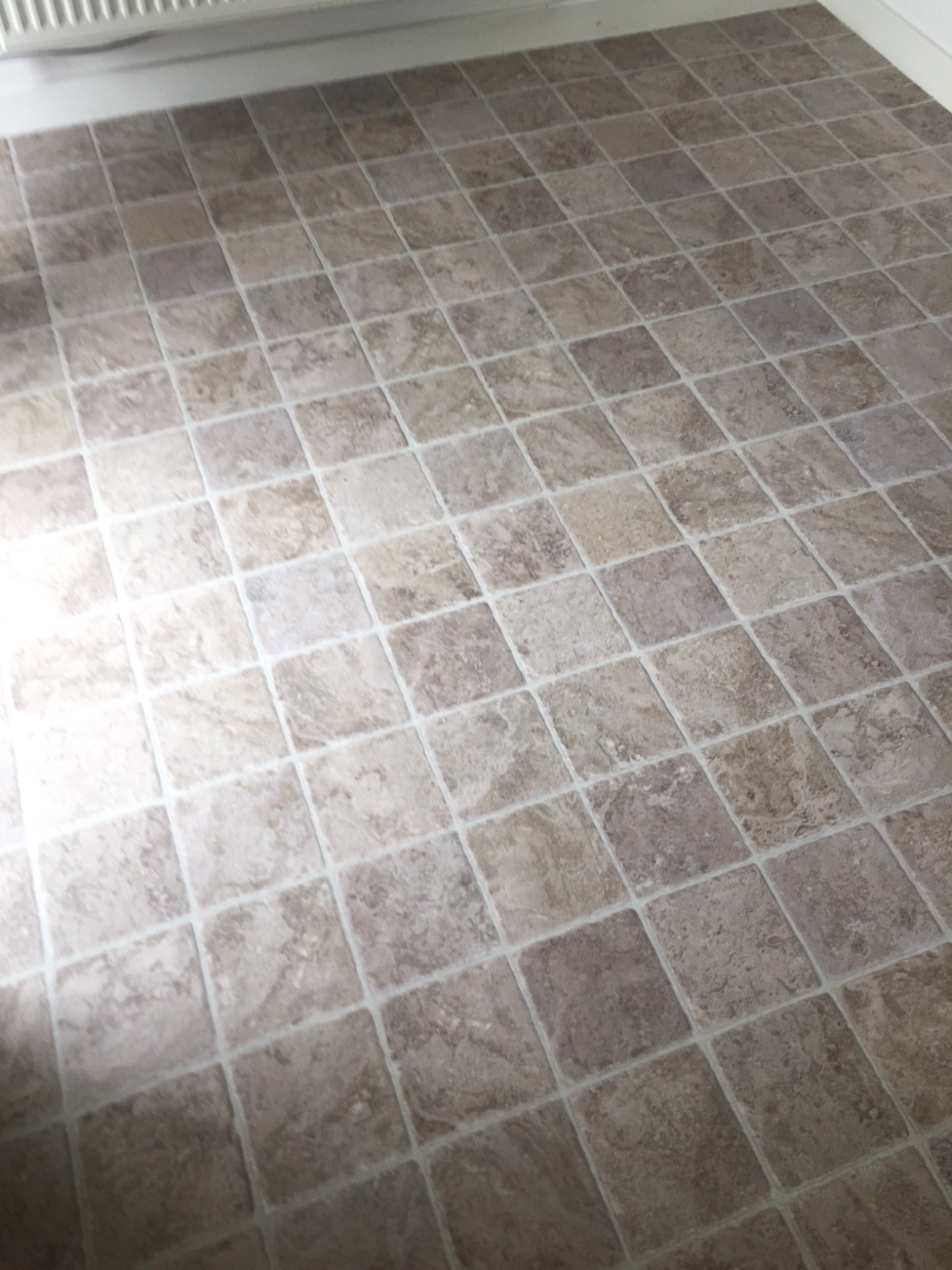 light brown vinyl flooring with tile design in kitchen 