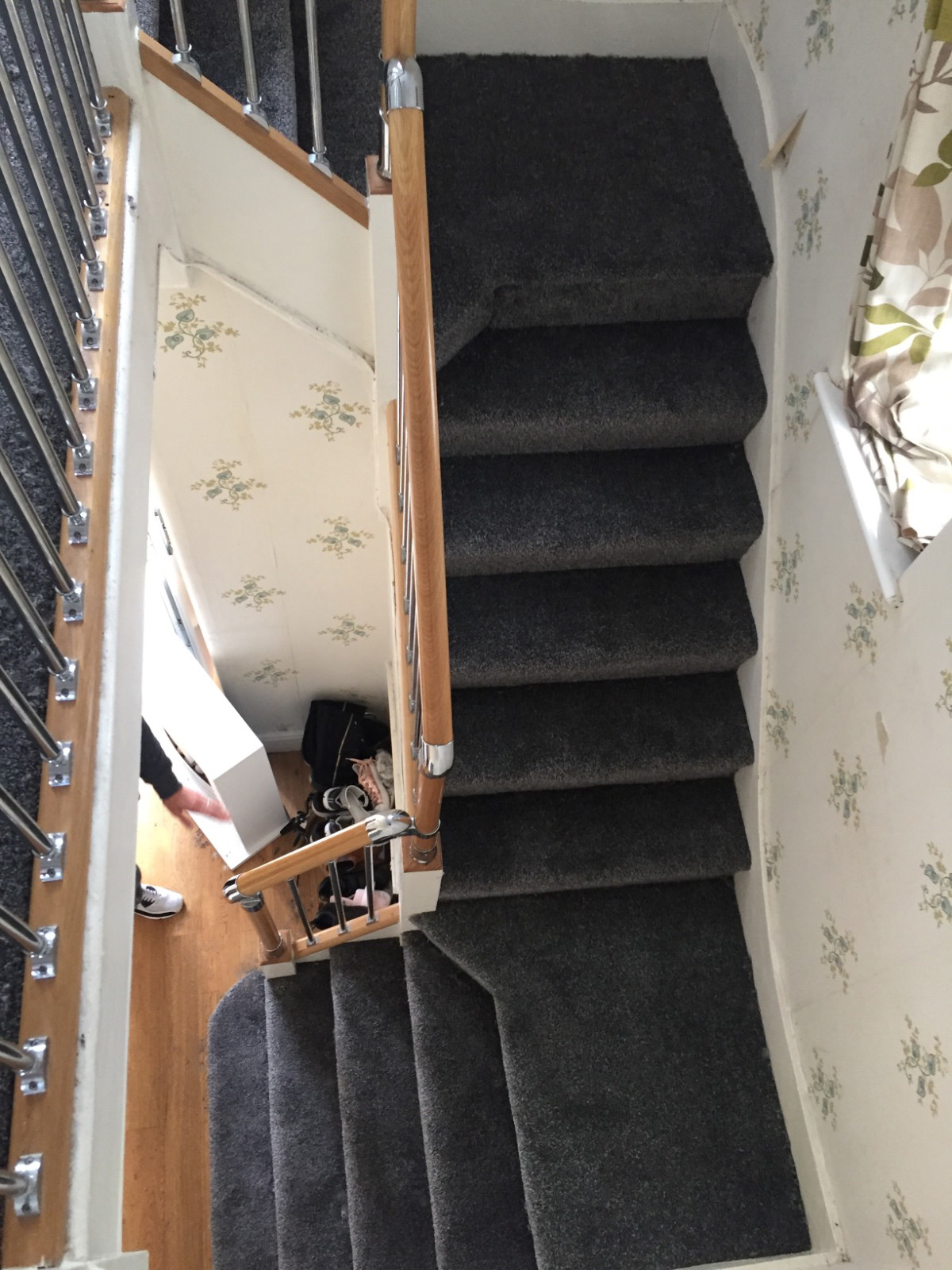 dark grey carpet fitted on staircase with brown banister 
