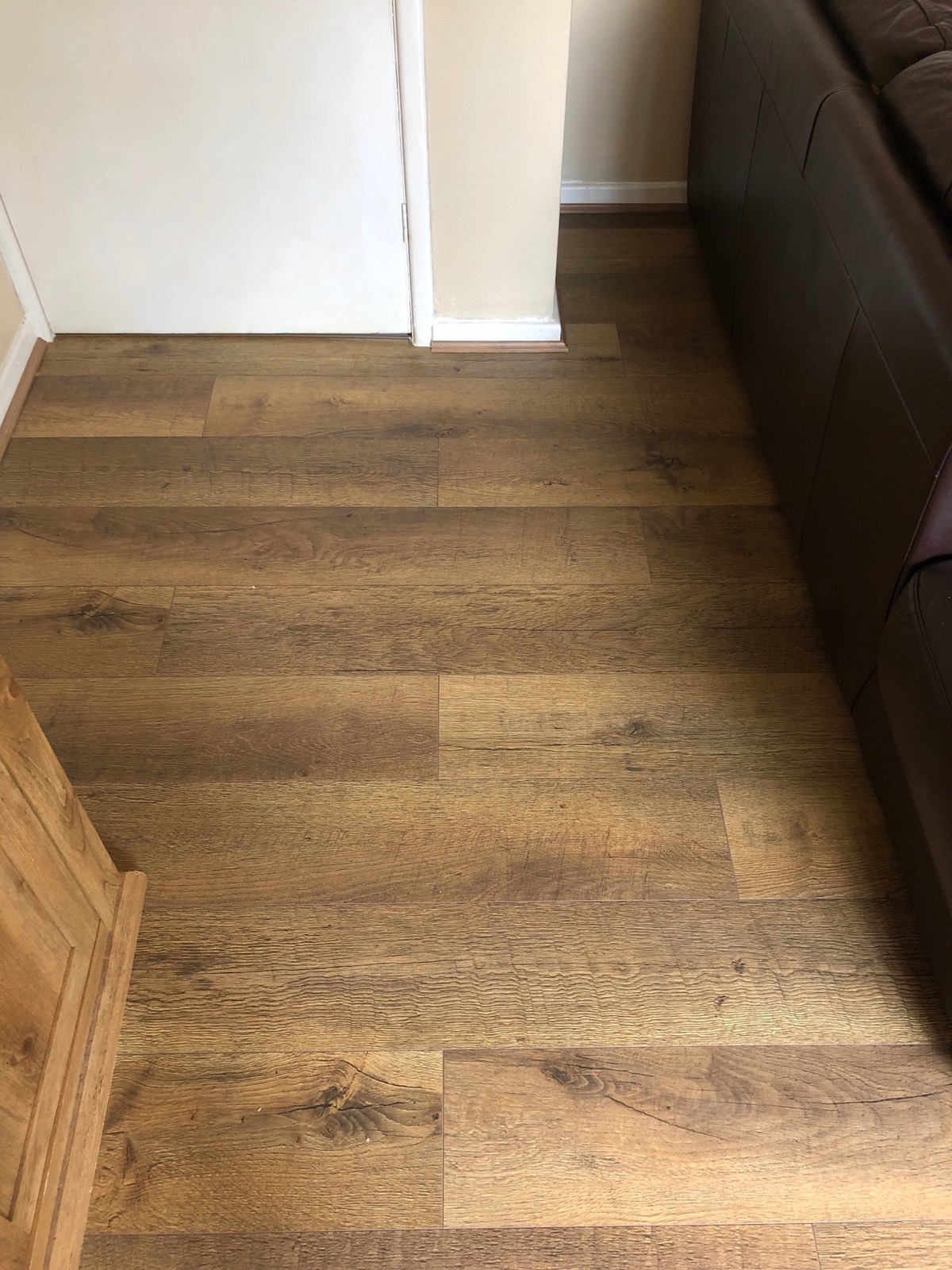 dark wooden laminate flooring fitted in living room 