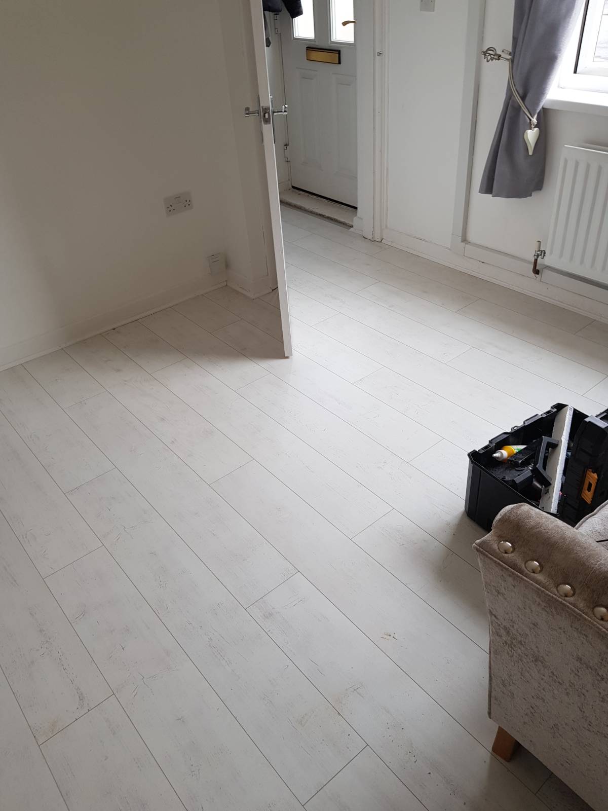 white laminate flooring fitting in living room area